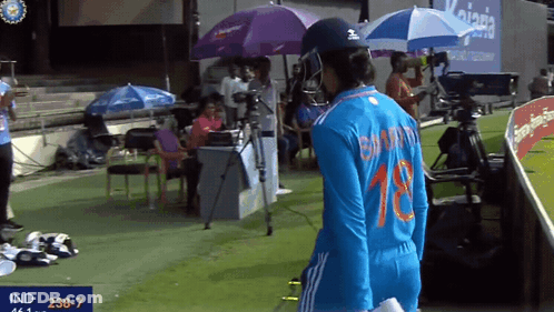 A Female Cricket Player Wearing A Number 18 Jersey GIF