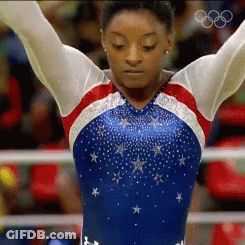 A Female Gymnast In A Red White And Blue Leotard With Stars On It GIF