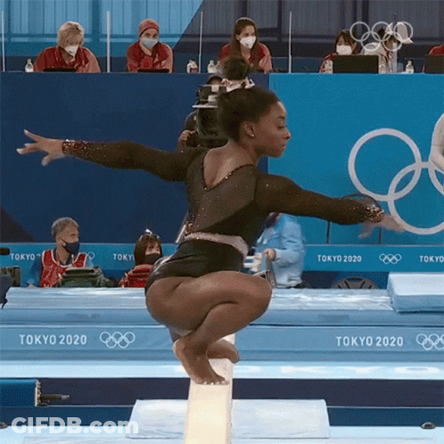 A Female Gymnast Is Doing A Trick On A Balance Beam At The Tokyo Olympics GIF