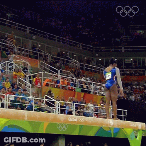 A Female Gymnast Stands On A Balance Beam At The Rio 2016 Olympic Games GIF