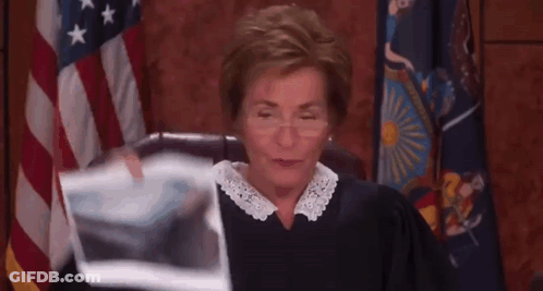 A Female Judge Is Holding A Piece Of Paper In Front Of Her . GIF