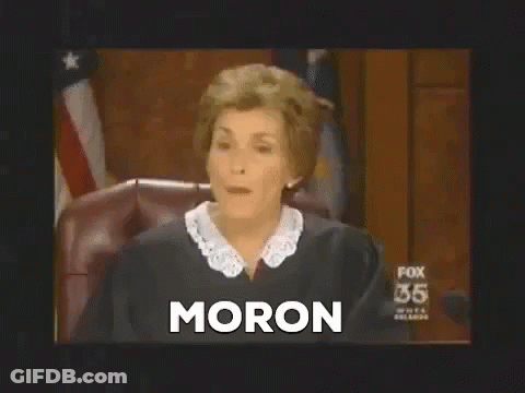 A Female Judge Is Sitting In A Courtroom And The Word Moron Is On The Screen . GIF