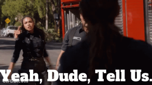 A Female Police Officer Says Yeah Dude Tell Us While Standing Next To A Man GIF