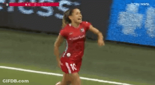 A Female Soccer Player In A Red Jersey With The Number 10 On It Is Running On The Field . GIF