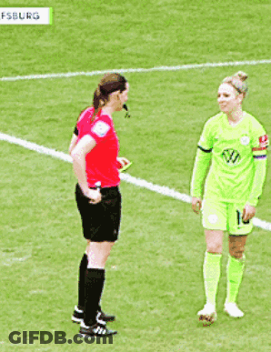 A Female Soccer Player With The Number 10 On Her Shorts Is Talking To A Referee GIF