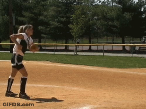 A Female Softball Player Throws A Ball While Standing On A Field GIF