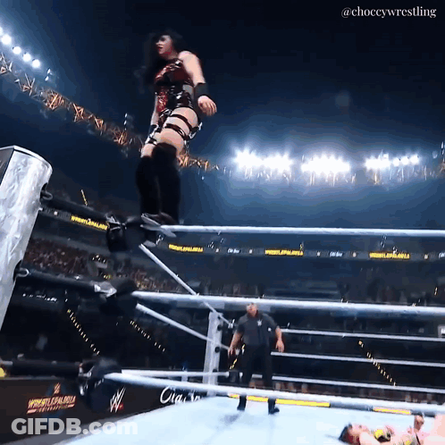 A Female Wrestler Jumps Over The Ropes At A Wrestlemania GIF