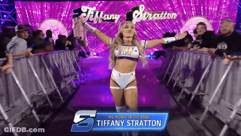 A Female Wrestler Named Tiffany Stratton Is Walking Through A Ring GIF