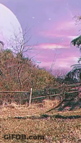 A Fence In A Field With A Full Moon In The Background GIF