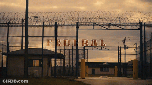 A Fence With Barbed Wire And The Word Federal Written On It GIF