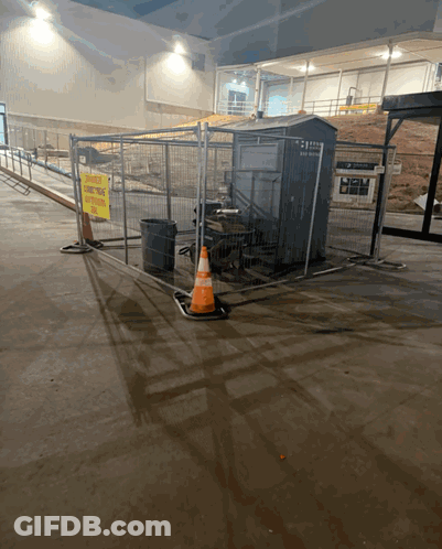 A Fenced In Area With A Yellow Sign That Says " No Smoking " GIF