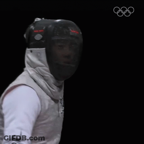 A Fencer Is Wearing A Helmet And Holding A Sword GIF