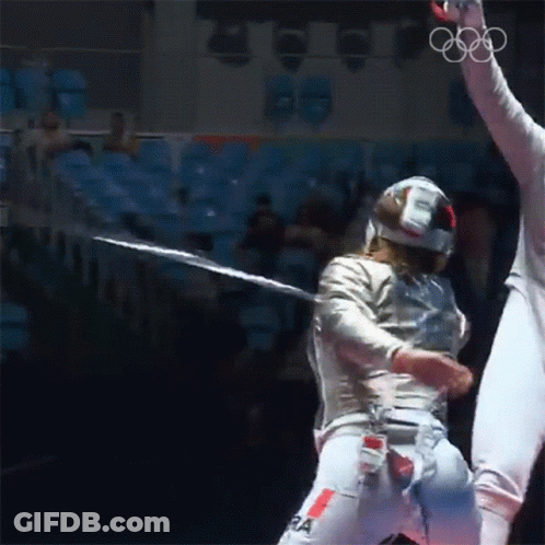 A Fencer Wearing A Helmet And Pants With The Letter Ra On Them GIF