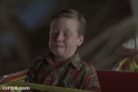 A Ferris Wheel Is Lit Up At Night GIF