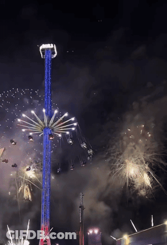 A Ferris Wheel Is Lit Up In Red White And Blue GIF