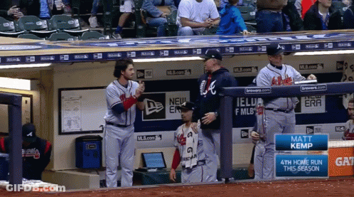 A Few Baseball Players Standing In A Dugout With A Sign That Says Matt Kemp GIF