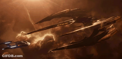 A Few Spaceships Are Flying In A Cloudy Sky GIF