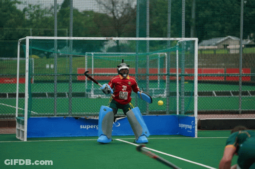 A Field Hockey Player Wearing A Red Jersey With The Number 21 On It GIF
