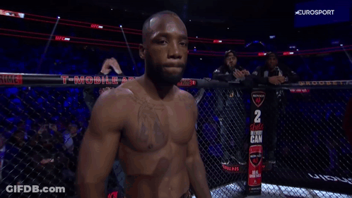 A Fighter In A Cage With A Sign That Says 2 Choice In Every Can On It GIF