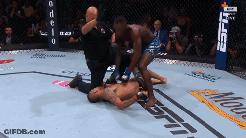 A Fighter Is Laying On The Ground In A Boxing Ring With The Espn Logo In The Background GIF