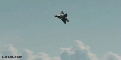 A Fighter Jet Flies Through A Cloudy Sky GIF