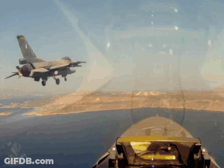 Fighter Jet Flying Over Water And Mountains GIF