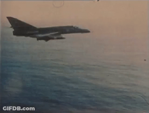 A Fighter Jet Is Flying Over A Body Of Water With The Number 21 On The Side GIF