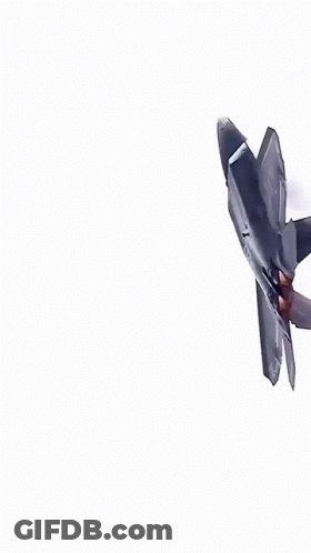 A Fighter Jet Is Flying Through A Blue Sky With White Clouds GIF