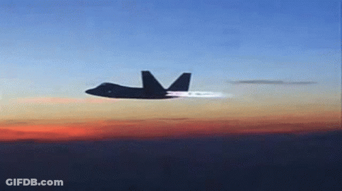 A Fighter Jet Is Flying Through A Cloudy Sky GIF