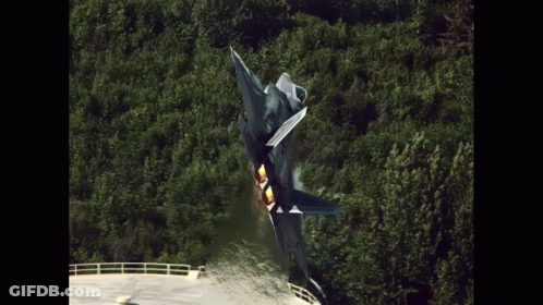 A Fighter Jet Is Taking Off From A Runway In The Woods GIF