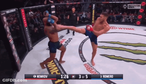 A Fighter Kicking Another Fighter In A Boxing Ring With The Score Of 3 To 5 GIF