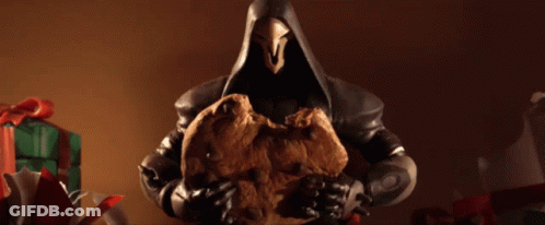 A Figurine Of Reaper Holding A Cookie In Front Of Gifts GIF