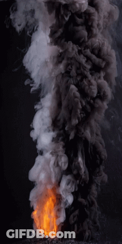 A Fire With Smoke Coming Out Of It On A Dark Background GIF