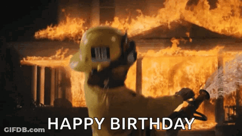 A Fireman Is Standing In Front Of A Burning House Holding A Hose And Saying Happy Birthday . GIF
