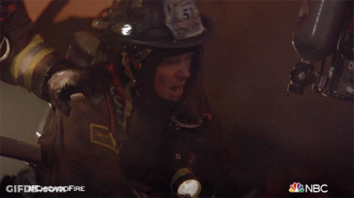 A Fireman With The Number 51 On His Helmet Holds A Flashlight GIF