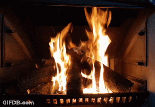 A Fireplace With A Lot Of Logs Burning And A Few Letters On The Bottom GIF