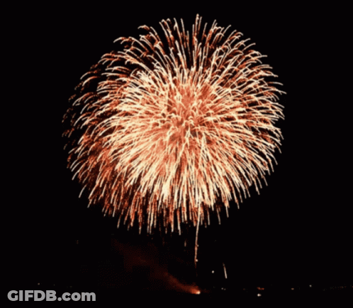 A Fireworks Display In The Night Sky With A Large Firework In The Middle GIF