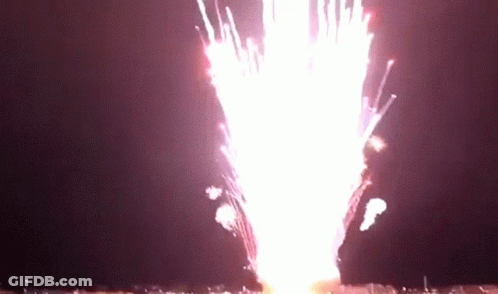 A Fireworks Display Is Going Off In The Dark GIF