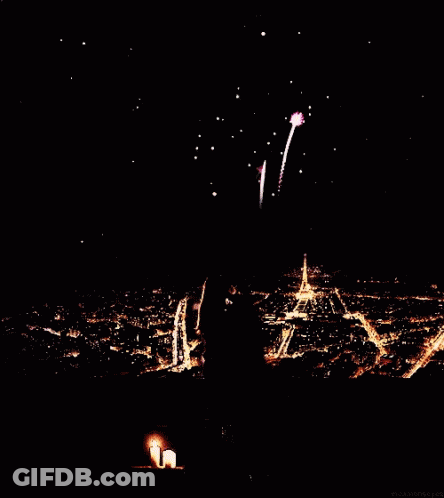A Fireworks Display Over A City At Night With The Eiffel Tower In The Background GIF