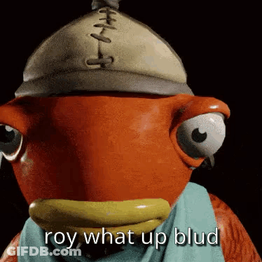 A Fish Wearing A Hat And Scarf With The Words `` Roy What Up Blud '' Written On It . GIF