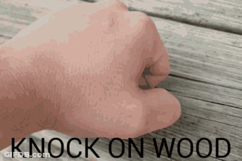 A Fist Is Shown With The Words Knock On Wood Above It GIF