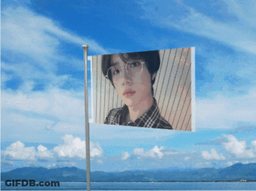 A Flag With A Picture Of A Man With Glasses On It GIF