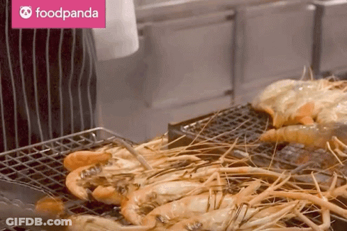 A Foodpanda Logo Can Be Seen Behind A Grilled Shrimp GIF
