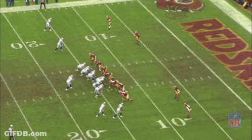 A Football Field With A Large Redskins Logo On It GIF