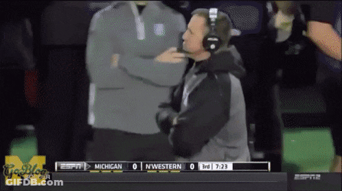 A Football Game Between Michigan And Nwestern Is Being Played On Espn GIF