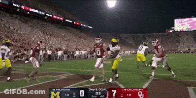 A Football Game Between Michigan And Oklahoma Is Being Played GIF