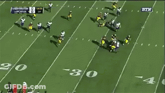 A Football Game Between Michigan And Washington Is Being Played GIF