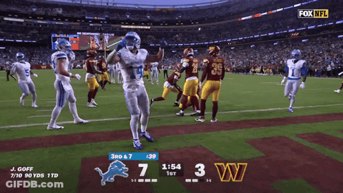 A Football Game Between The Detroit Lions And The Redskins GIF