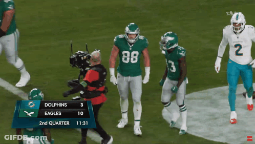 A Football Game Between The Dolphins And Eagles Is Being Played GIF