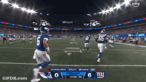 A Football Game Between The Patriots And New York Giants GIF
